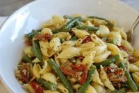 Sun-Drenched Pesto Pasta with Garden Beans and Tangy Tomatoes