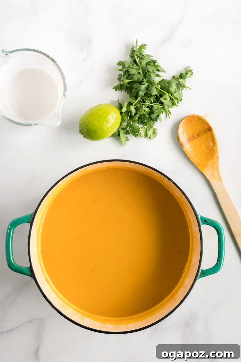 Velvety Butternut Curry Dream 7 A pot of fully pureed Curried Butternut Squash Soup, ready for the final additions of coconut milk, lime, and cilantro.