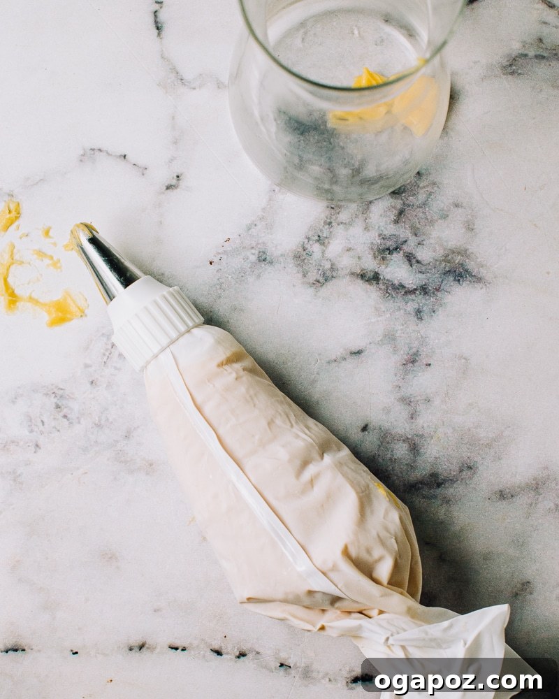 Airy French Delights 12 Choux pastry batter in a pastry bag with a star tip, ready for chilling.