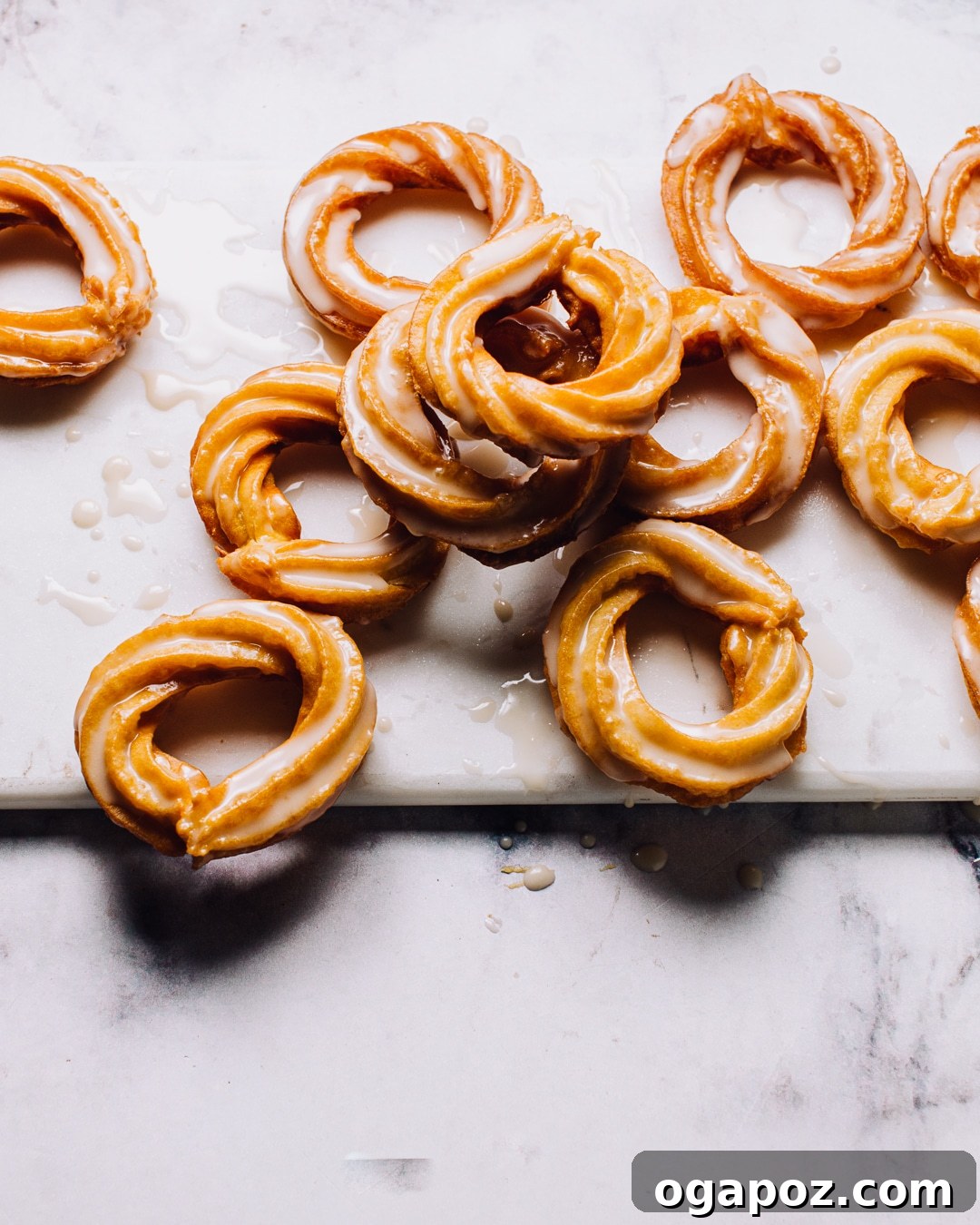 Airy French Delights 3 Close-up of a stack of golden brown homemade French Crullers, showcasing their distinctive ridges and inviting texture.