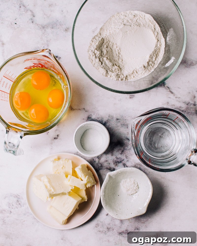 Airy French Delights 4 Step-by-step image of choux pastry dough being prepared in a stand mixer, demonstrating the texture needed.
