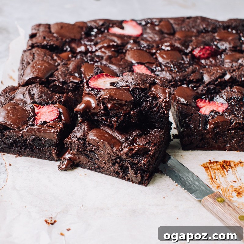 Fudgy Strawberry Swirl Brownies 11 Stacked fudgy strawberry brownies with chocolate chunks and fresh strawberries