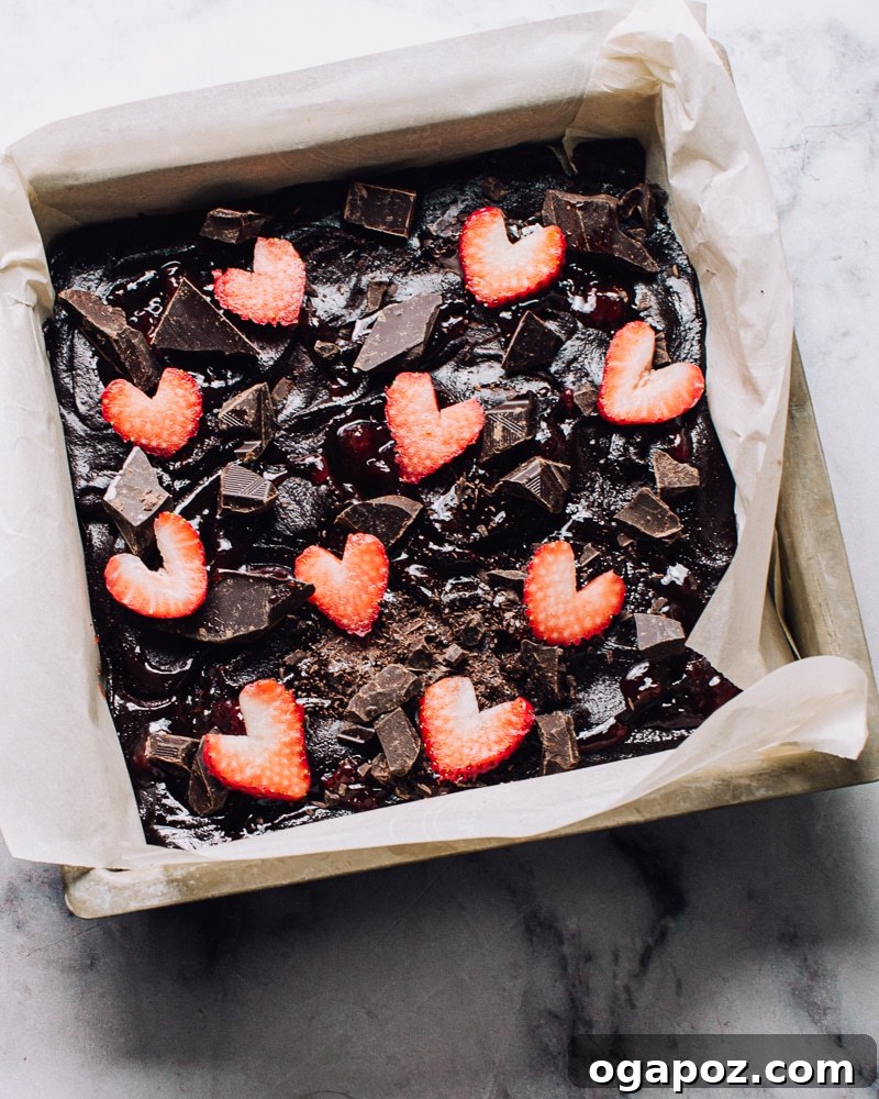 Fudgy Strawberry Swirl Brownies 10 Brownie batter topped with strawberry hearts and chocolate chunks ready for baking