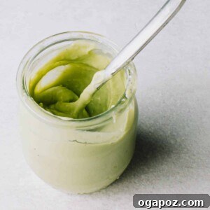 Velvet Avocado Crema 7 Avocado Crema in a jar with a spoon.