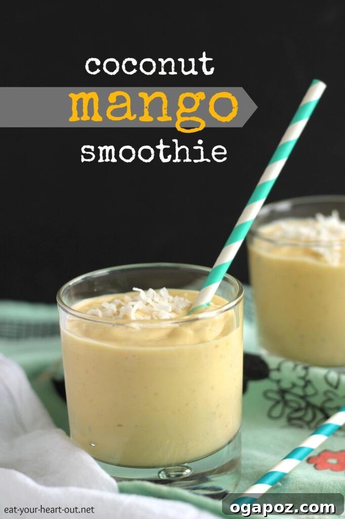 Tropical Mango Coconut Delight 2 Delicious Coconut Mango Smoothie in a glass with a straw, garnished with fresh mango and coconut flakes.