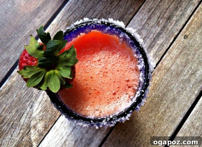 Strawberry Mango Sunset Margarita 4 Strawberry Mango Margarita in a glass with a salted rim