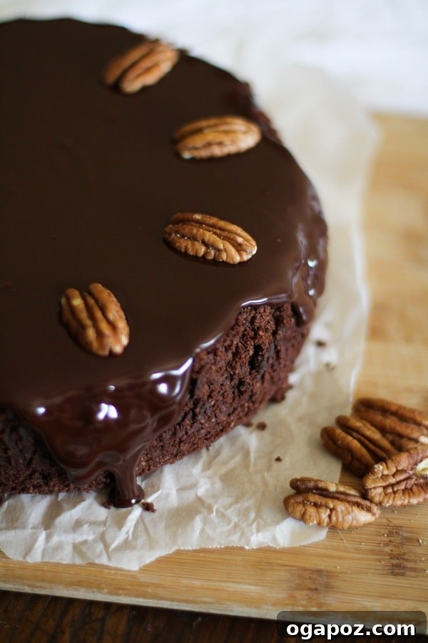 Ultimate Gluten-Free Chocolate Coconut Ganache Delight 5 A beautifully decorated Gluten-Free Chocolate Cake with Coconut-Chocolate Ganache, garnished with fresh pecans.