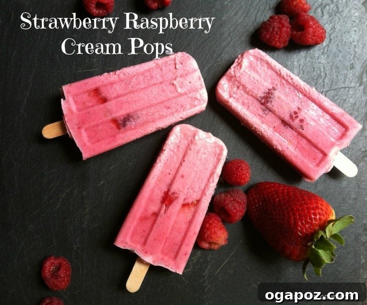 Strawberry Raspberry Dream Pops 2 Close-up of three Strawberry Raspberry Cream Pops showing their vibrant color and creamy texture, ideal for a summer treat.