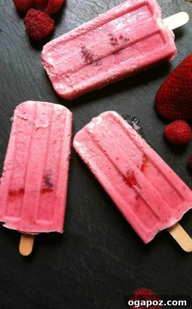 Strawberry Raspberry Dream Pops 5 A close-up shot of a single Strawberry Raspberry Cream Pop, showcasing its rich red and pink hues and appealing texture.