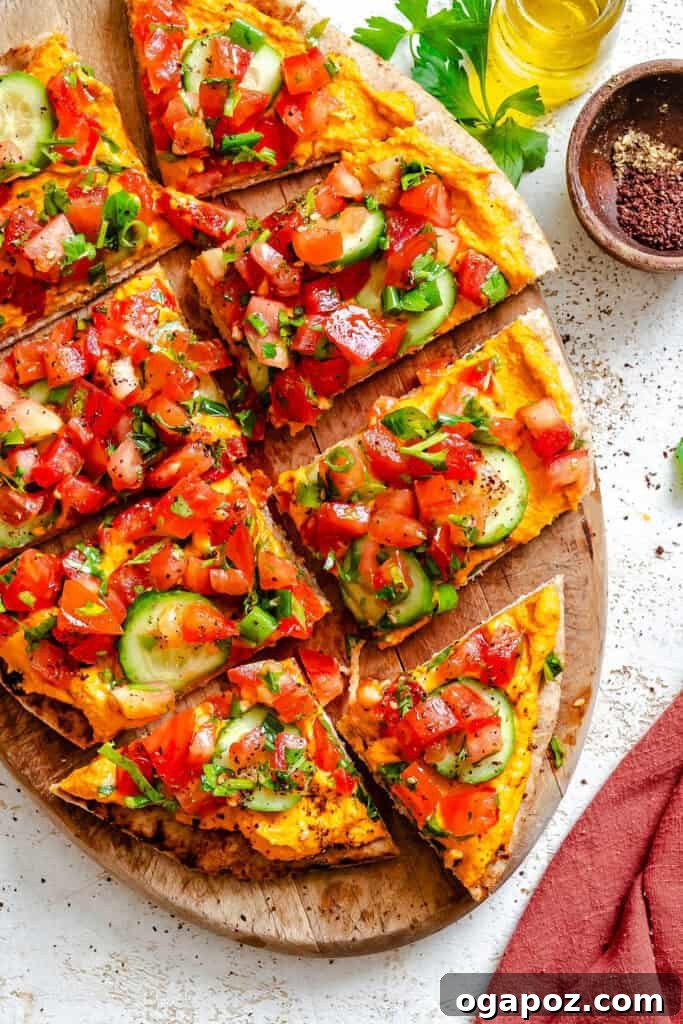 Sun-Kissed Mediterranean Flatbread Pizza 2 A beautifully presented Mediterranean Naan Pizza on a rustic wooden plate, garnished with fresh herbs, ready to be enjoyed.