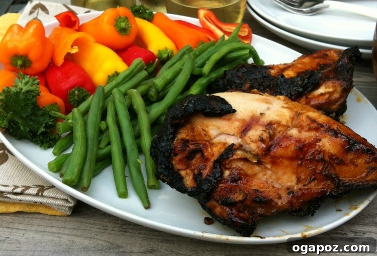 Sweet Heat Honey-Lime Grilled Chicken 2 Spiced Honey Lime Grilled Chicken on a white plate garnished with fresh lime slices and cilantro