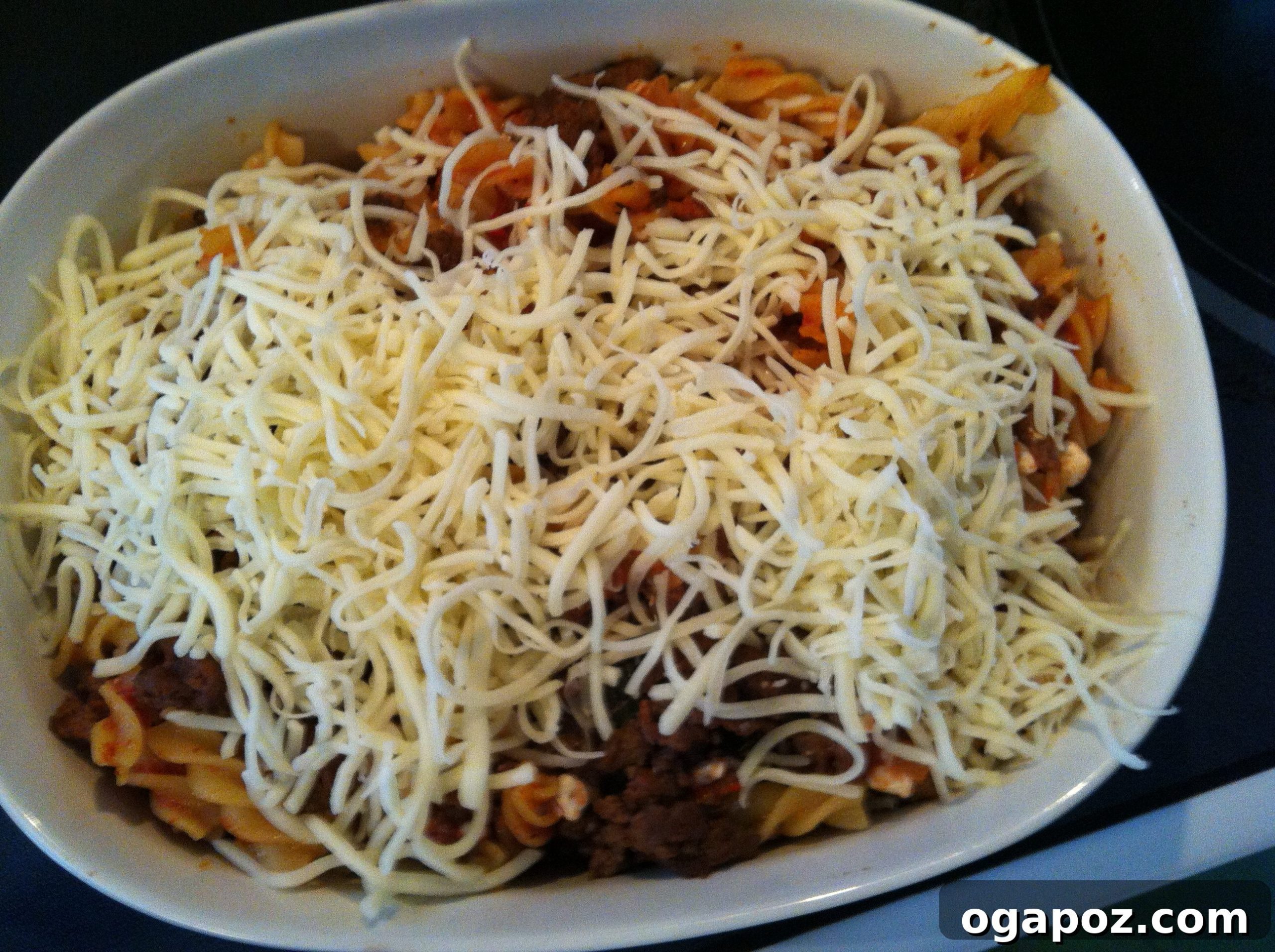IMG_4012 Generous serving of cheesy Italian pasta bake, showcasing layers of pasta, meat, and sauce