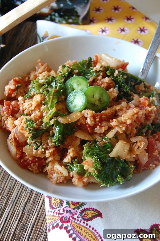 Fiesta Cauliflower Rice 3 Close-up of Spanish Cauliflower Rice, showcasing texture and colorful ingredients like tomatoes and kale