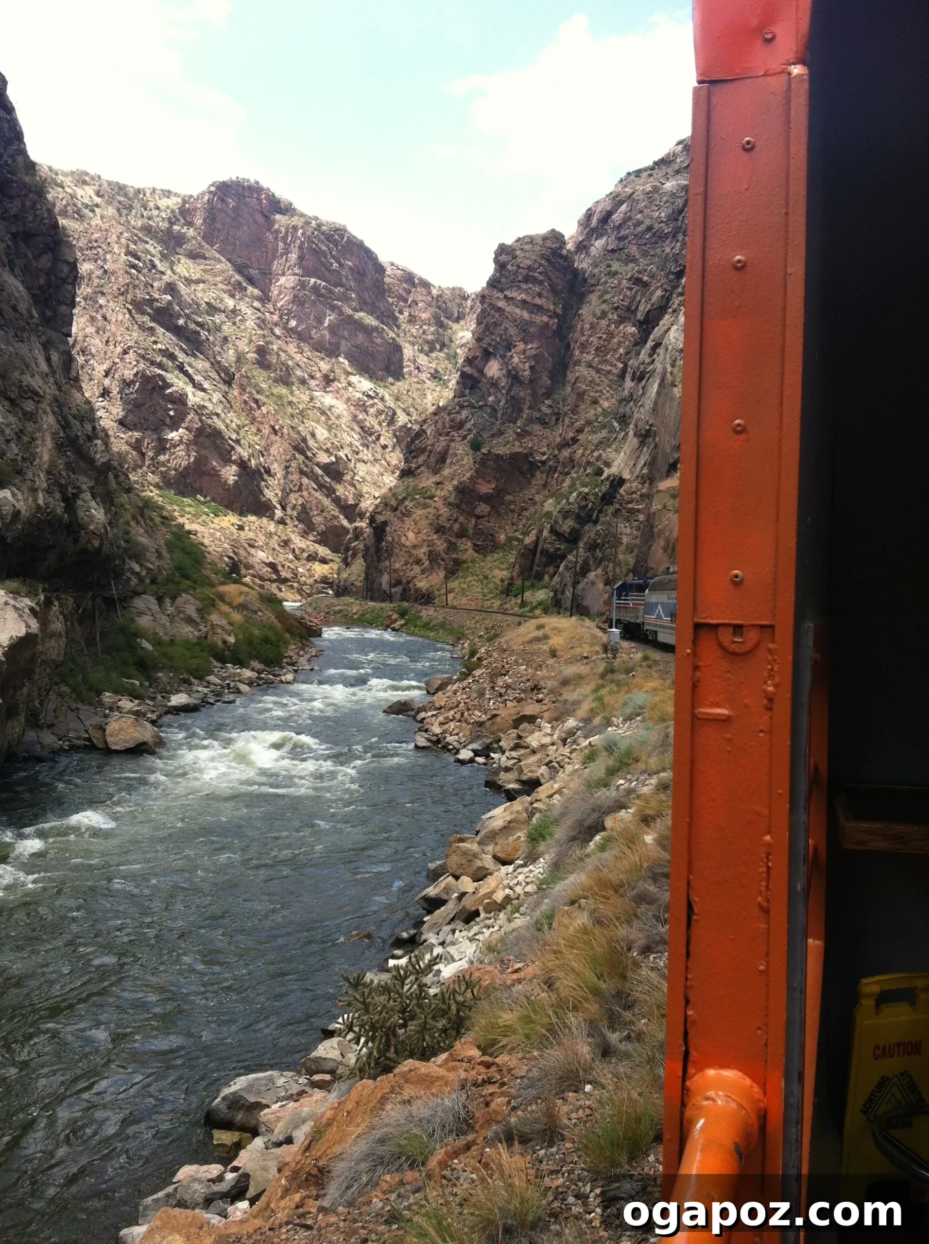 Family enjoying a scenic train ride through the Colorado mountains, capturing the journey