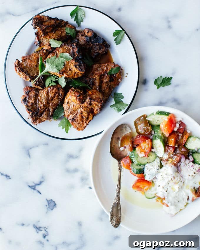 Spicy Harissa Lamb Chops and Cooling Cucumber Yogurt 2 Perfectly grilled harissa lamb chops resting on a plate, ready to be served.