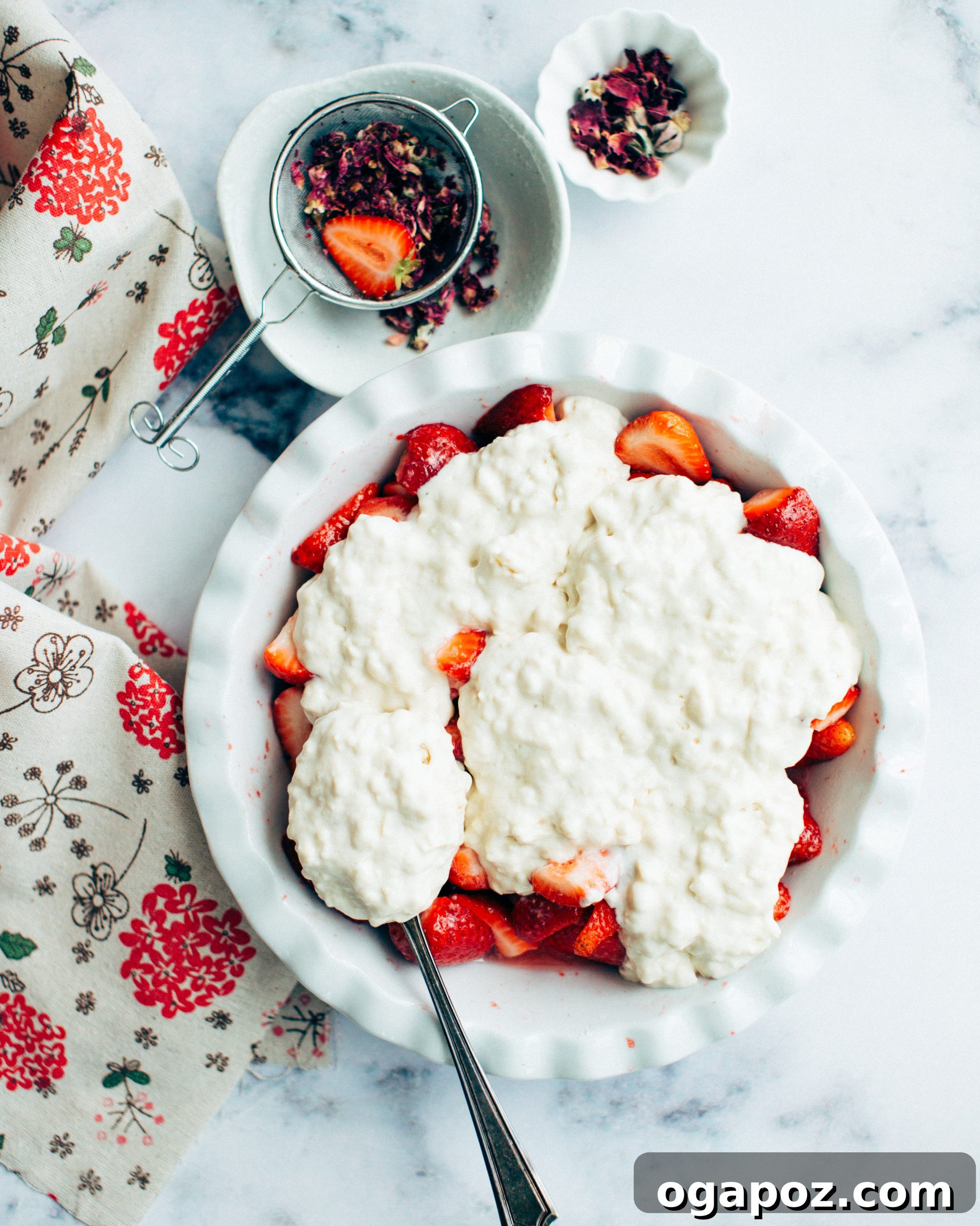 Sweet Strawberry Comfort 5 The unbaked strawberry cobbler in a baking dish, with the biscuit topping spooned over the fruit.