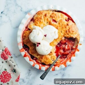 Sweet Strawberry Comfort 7 Strawberry Cobbler with ice cream and a spoon.