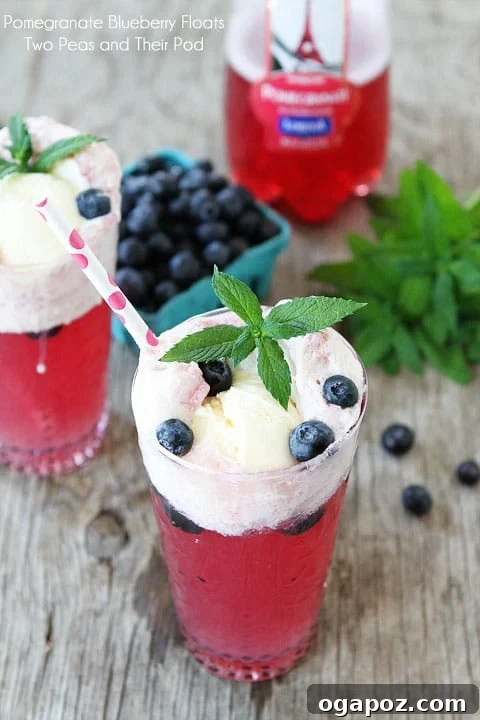 85 Summer Sips to Beat the Heat 4 Pomegranate Blueberry Floats in tall glasses with whipped cream and berries