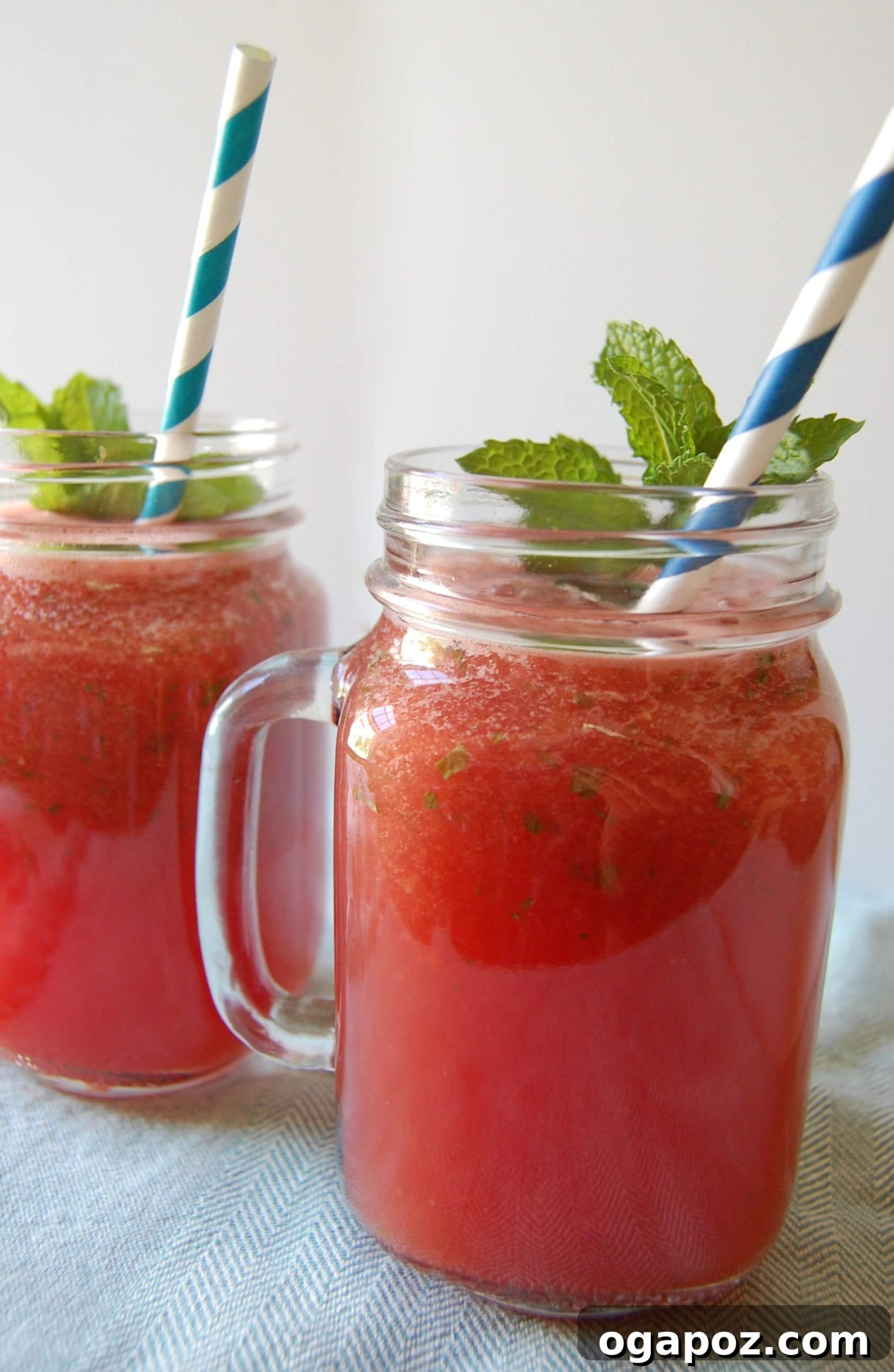 85 Summer Sips to Beat the Heat 9 Watermelon Lemonade Vodka Slushy in a glass with a lime garnish