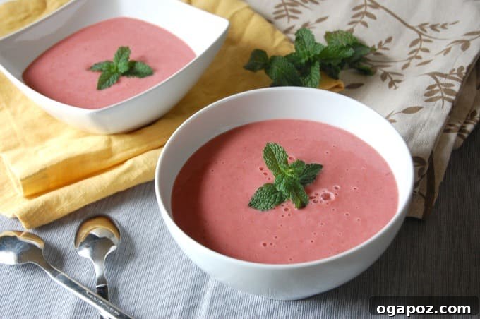 Ruby Mint Gazpacho 3 Close-up of Strawberry Mint Gazpacho in a pristine white bowl, garnished with a sprig of mint.