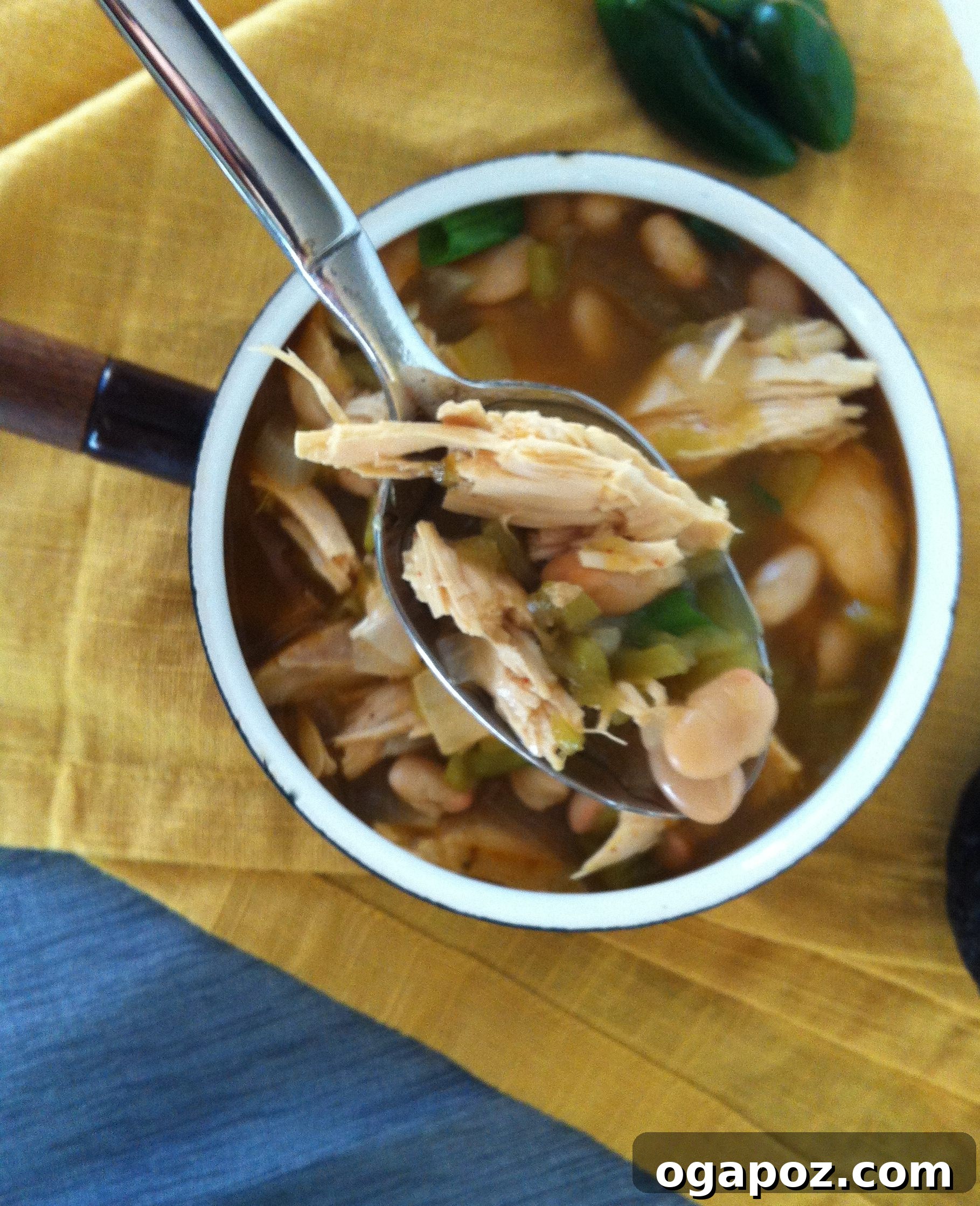 Ultimate White Chicken Chili 4 Close-up of a generous bowl of White Chicken Chili, beautifully garnished with vibrant green cilantro leaves.