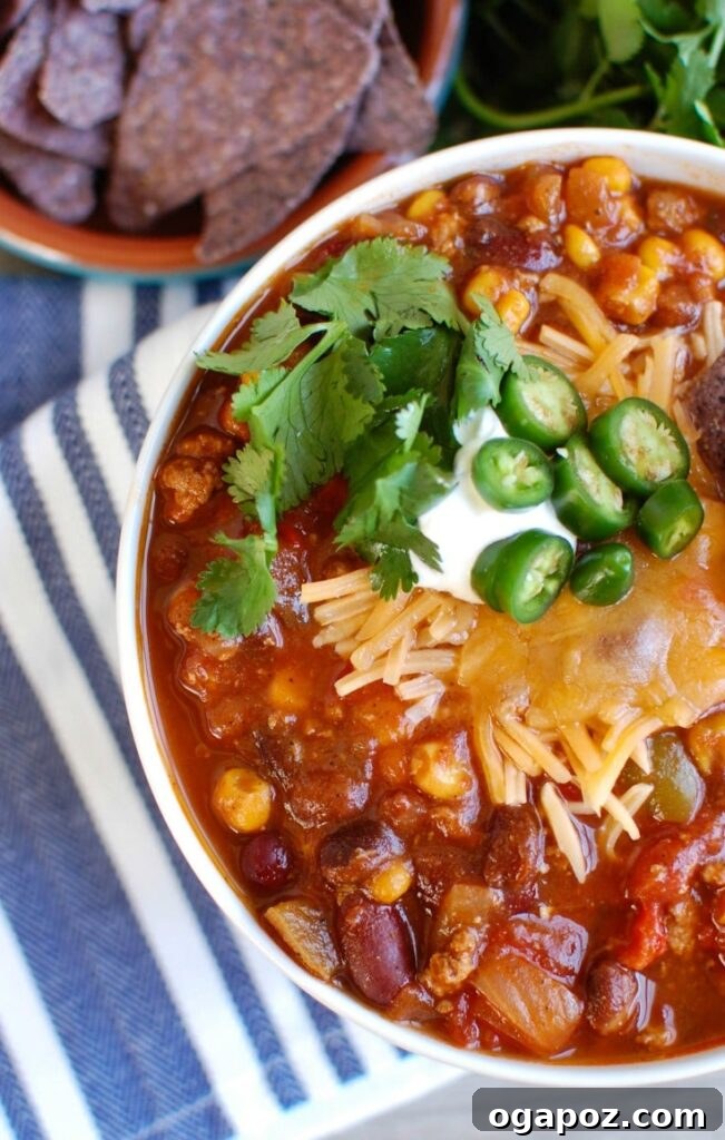 Hearty Slow Cooker Turkey Chili 3 A bowl of Slow Cooker Turkey Chili topped with sour cream and green onions, ready to be enjoyed.