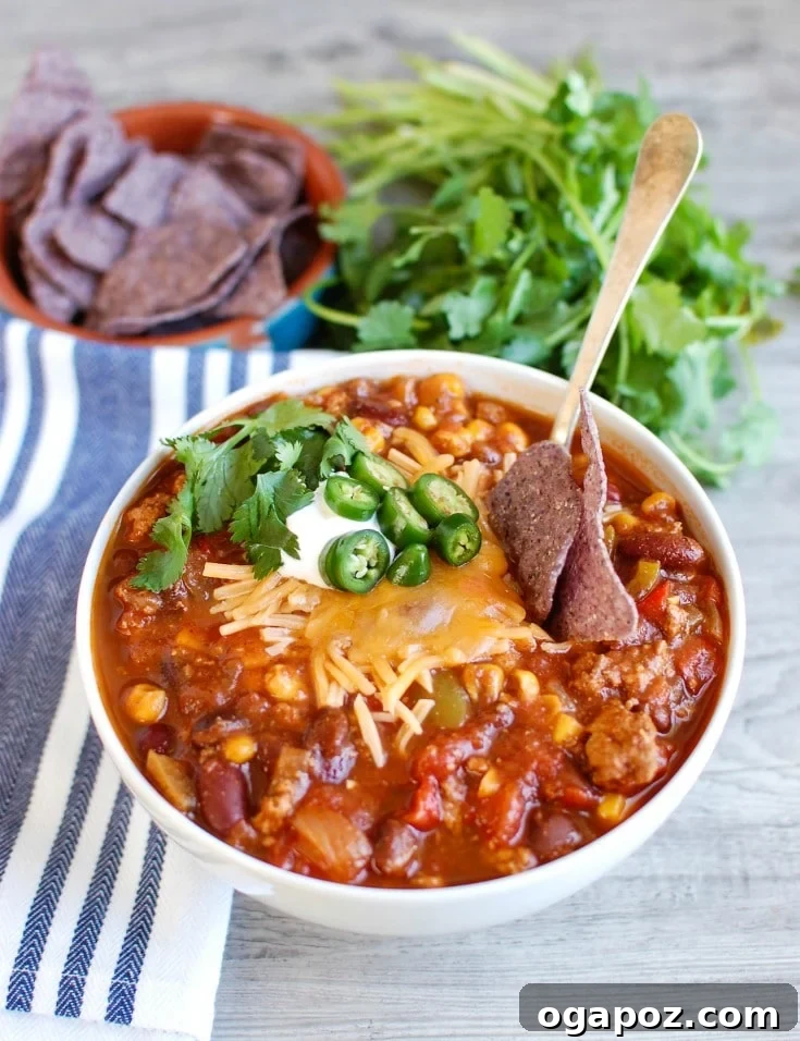 Hearty Slow Cooker Turkey Chili 4 Slow Cooker Turkey Chili served in a bowl with tortilla chips on the side for dipping.