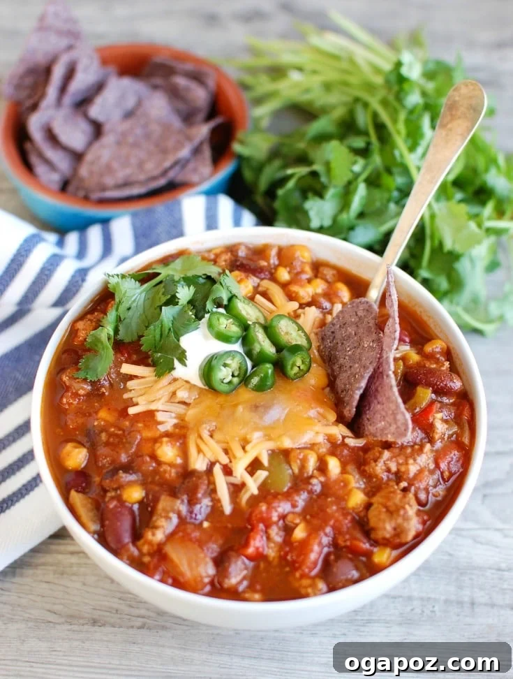 Hearty Slow Cooker Turkey Chili 5 A close-up shot of Slow Cooker Turkey Chili, garnished with vibrant green cilantro.