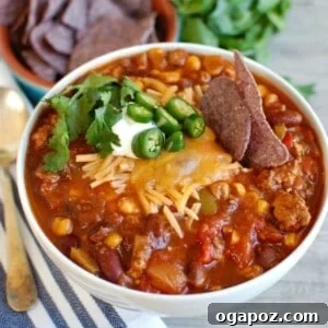 Hearty Slow Cooker Turkey Chili 6 A bowl of Slow Cooker Turkey Chili, garnished with fresh toppings