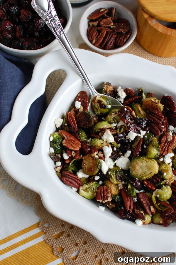 Maple-Glazed Brussels Sprouts with Bursting Cranberries 5 Overhead shot of Brussels Sprouts with Cranberries and cheese on a serving platter