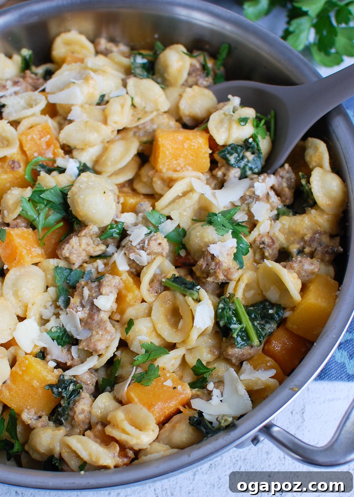 Golden Butternut Squash Pasta with Hearty Sausage 5 Butternut squash pasta with sausage and sage in a large skillet, ready to be served.