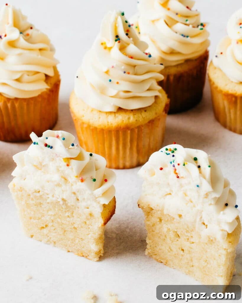 Velvet Vanilla Delights 2 A perfectly baked, fluffy vanilla cupcake with frosting on a plate, ready to be enjoyed.