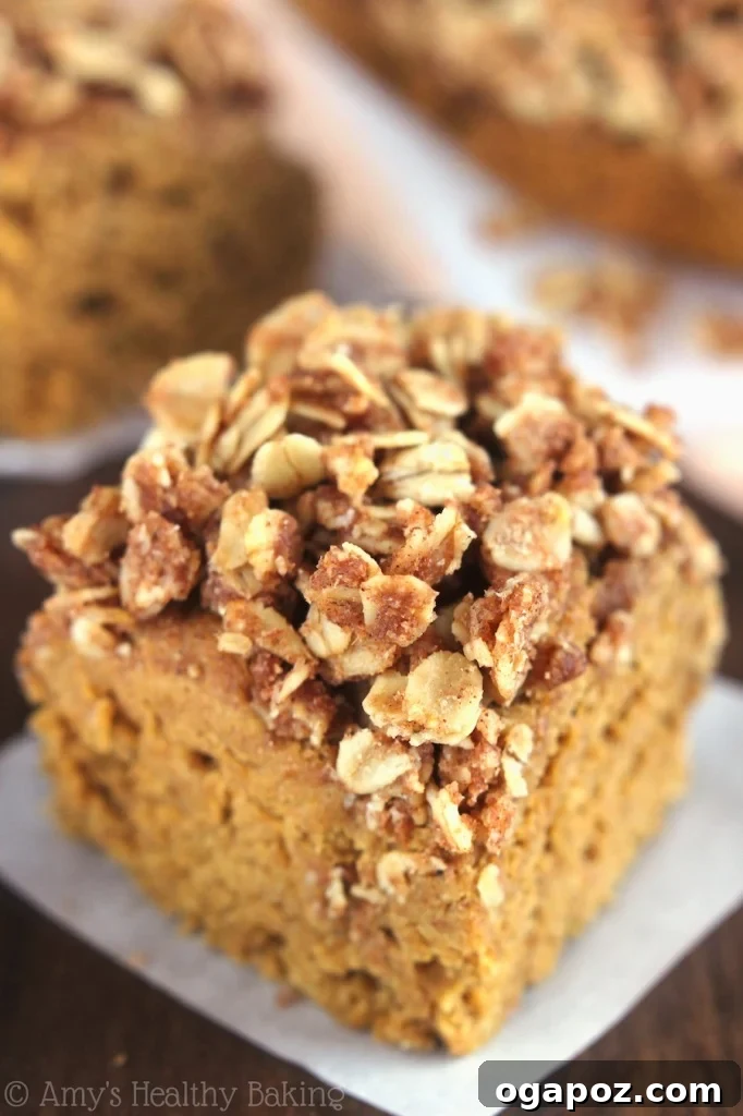 17 Stress-Free Slow Cooker Holiday Meals 10 A delicious slice of Slow Cooker Pumpkin Streusel Coffee Cake on a plate with a fork, ready to be enjoyed.