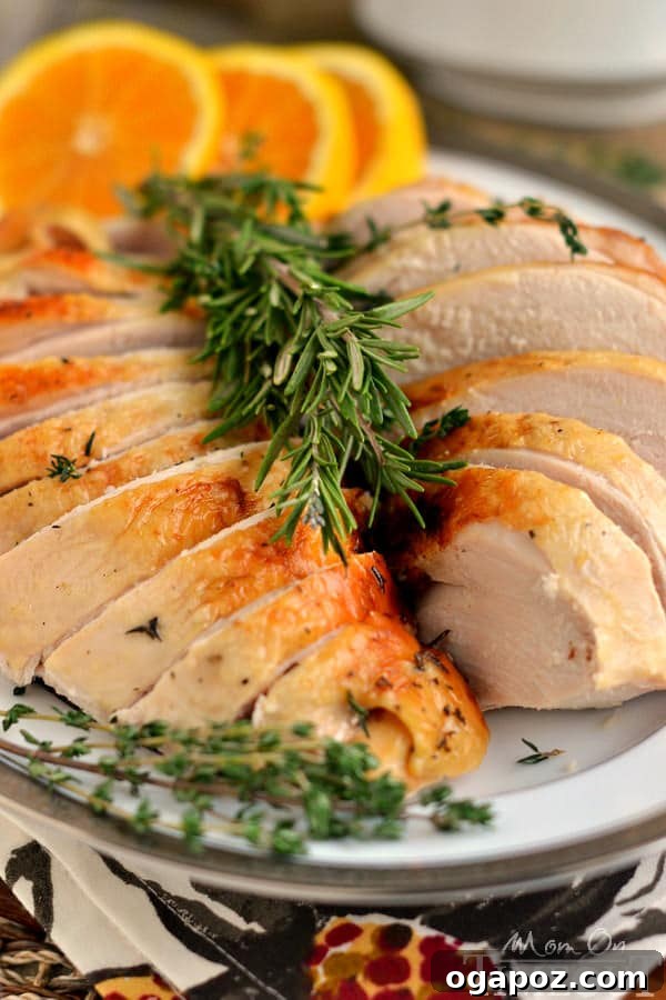 17 Stress-Free Slow Cooker Holiday Meals 7 Beautifully sliced Slow Cooker Citrus and Herb Turkey Breast, garnished with fresh herbs and citrus slices.