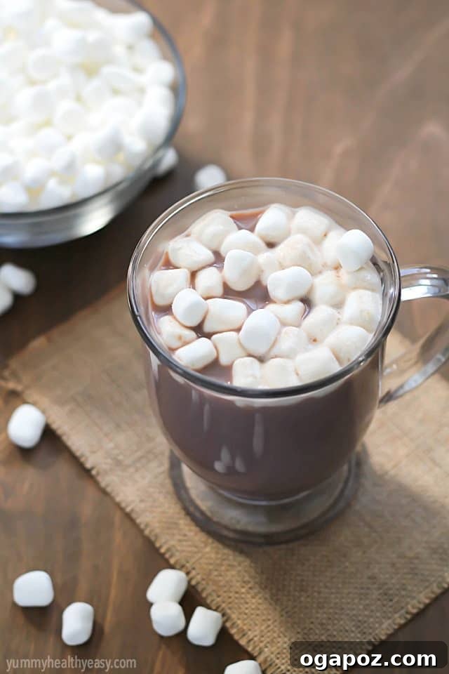 17 Stress-Free Slow Cooker Holiday Meals 9 Rich and creamy Crockpot Hot Chocolate in a rustic mug, topped generously with whipped cream and mini marshmallows.