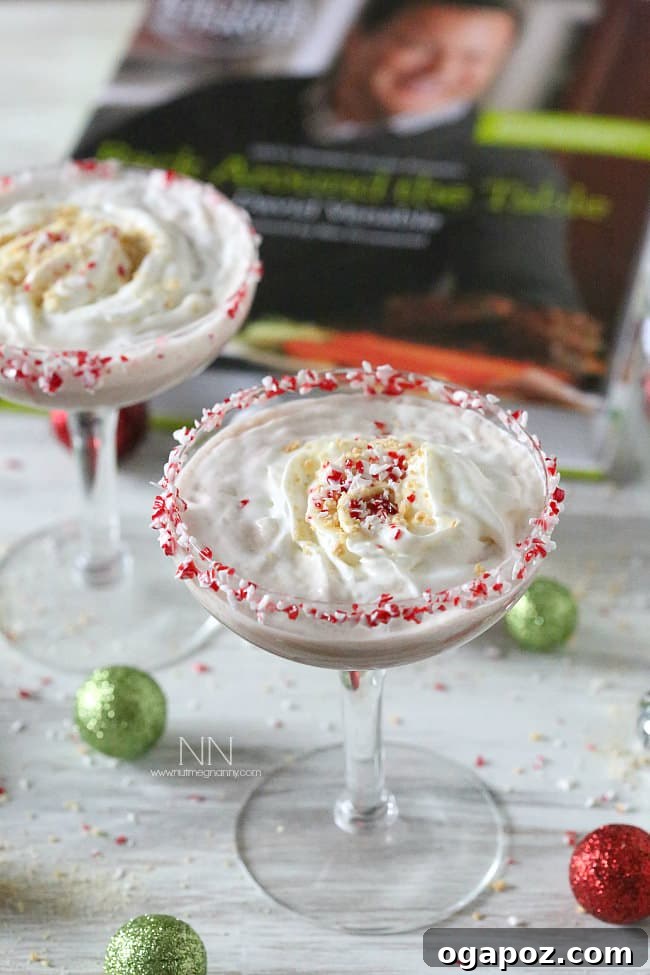 Sip into the Season: 41 Festive Drink Creations 10 A Peppermint S'mores Martini in a festive glass, topped with whipped cream and a toasted marshmallow, hinting at rich, sweet flavors.