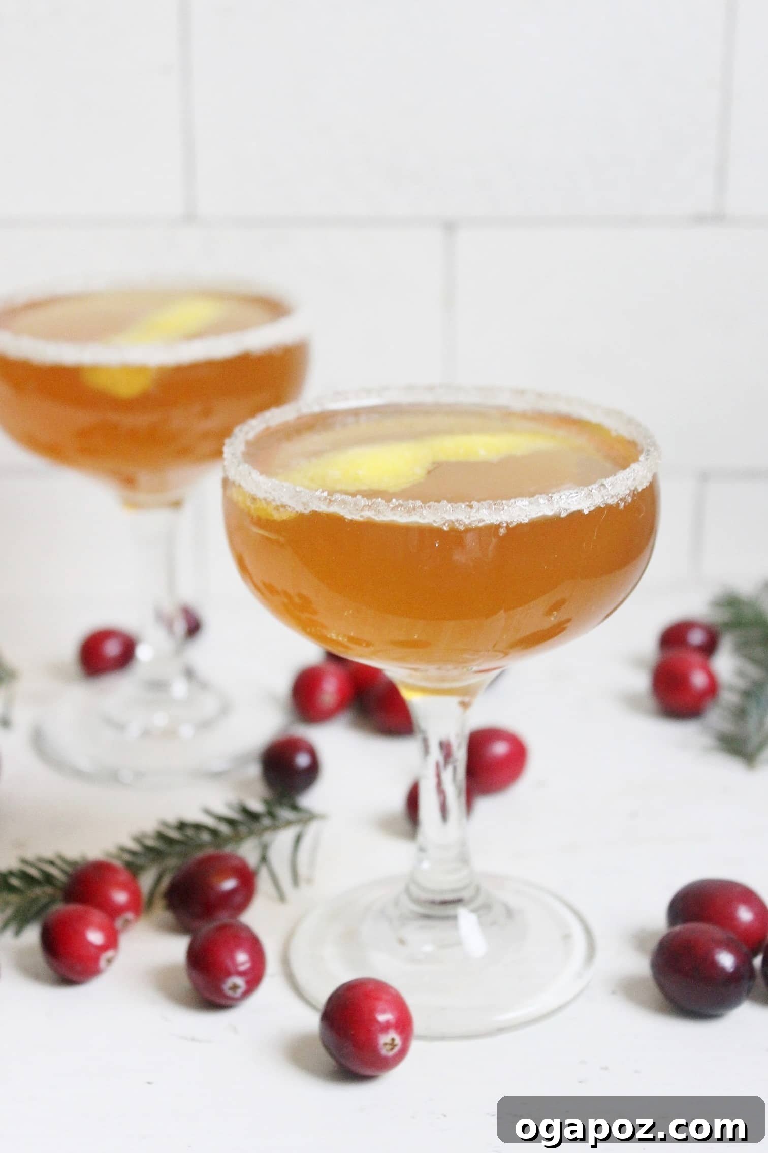 Sip into the Season: 41 Festive Drink Creations 7 An elegant Earl Grey French 75 cocktail in a coupe glass, garnished with a lemon twist, exuding sophistication.