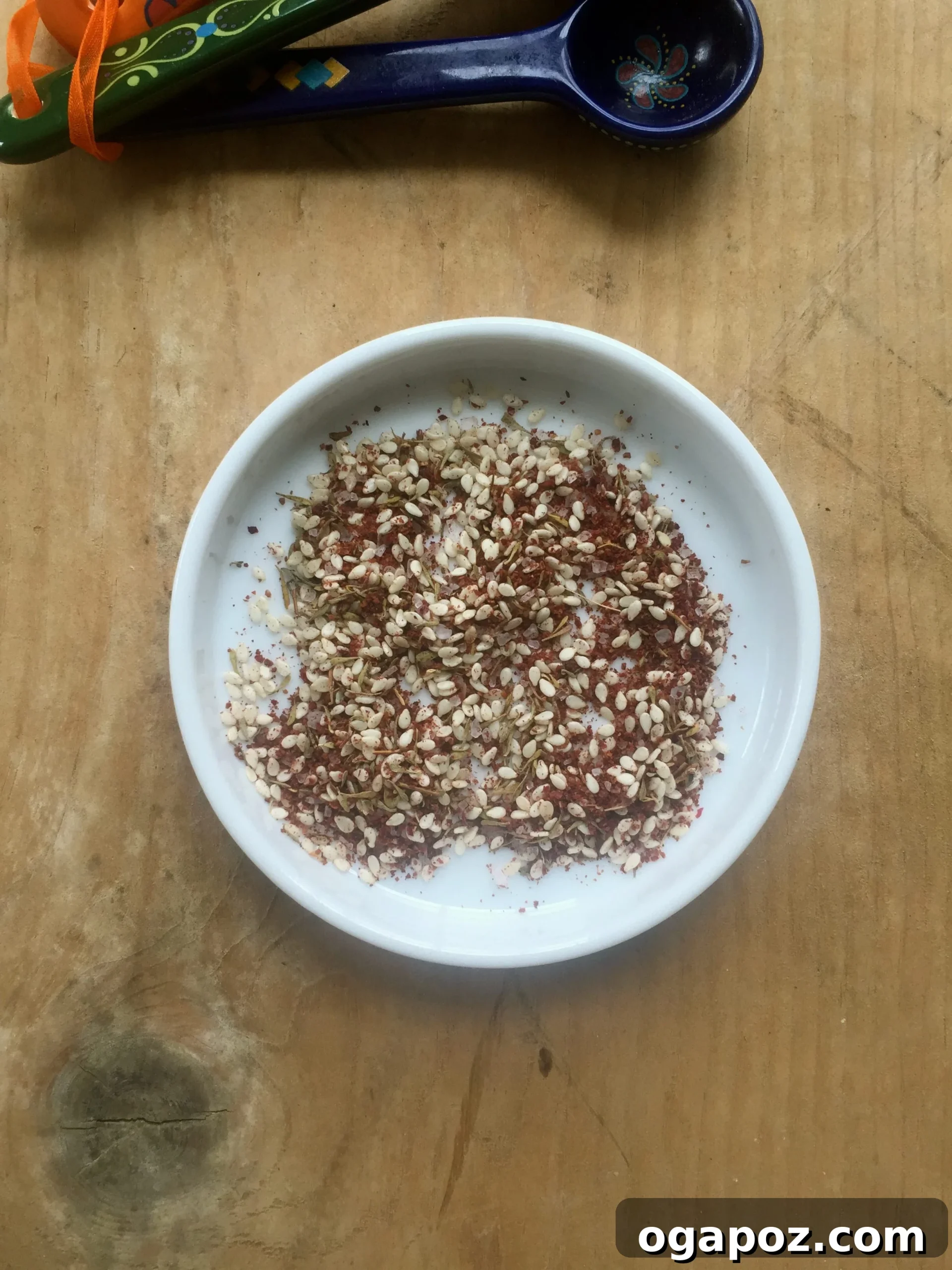 Wholesome Chickpea Chop 4 A small bowl of Za'atar spice blend, showcasing its vibrant color and texture.