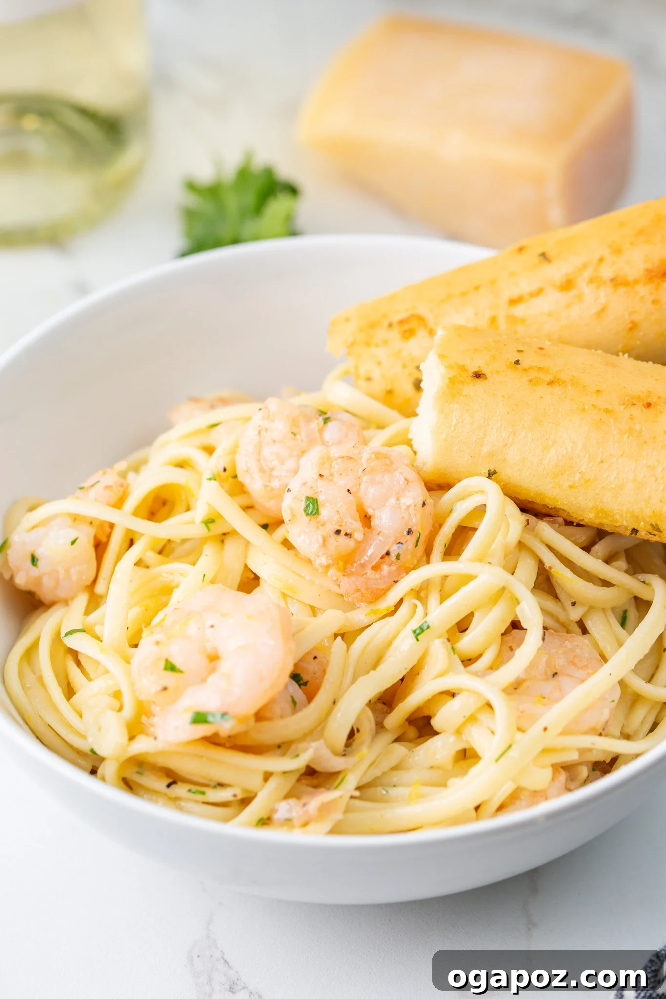 Sun-Kissed Lemon Garlic Shrimp Linguine 11 Lemon Garlic Shrimp Pasta served with a breadstick, ready to eat.