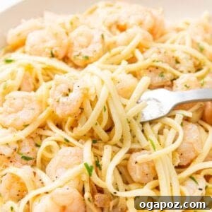 Sun-Kissed Lemon Garlic Shrimp Linguine 12 Lemon Garlic Shrimp Pasta in a bowl with a fork