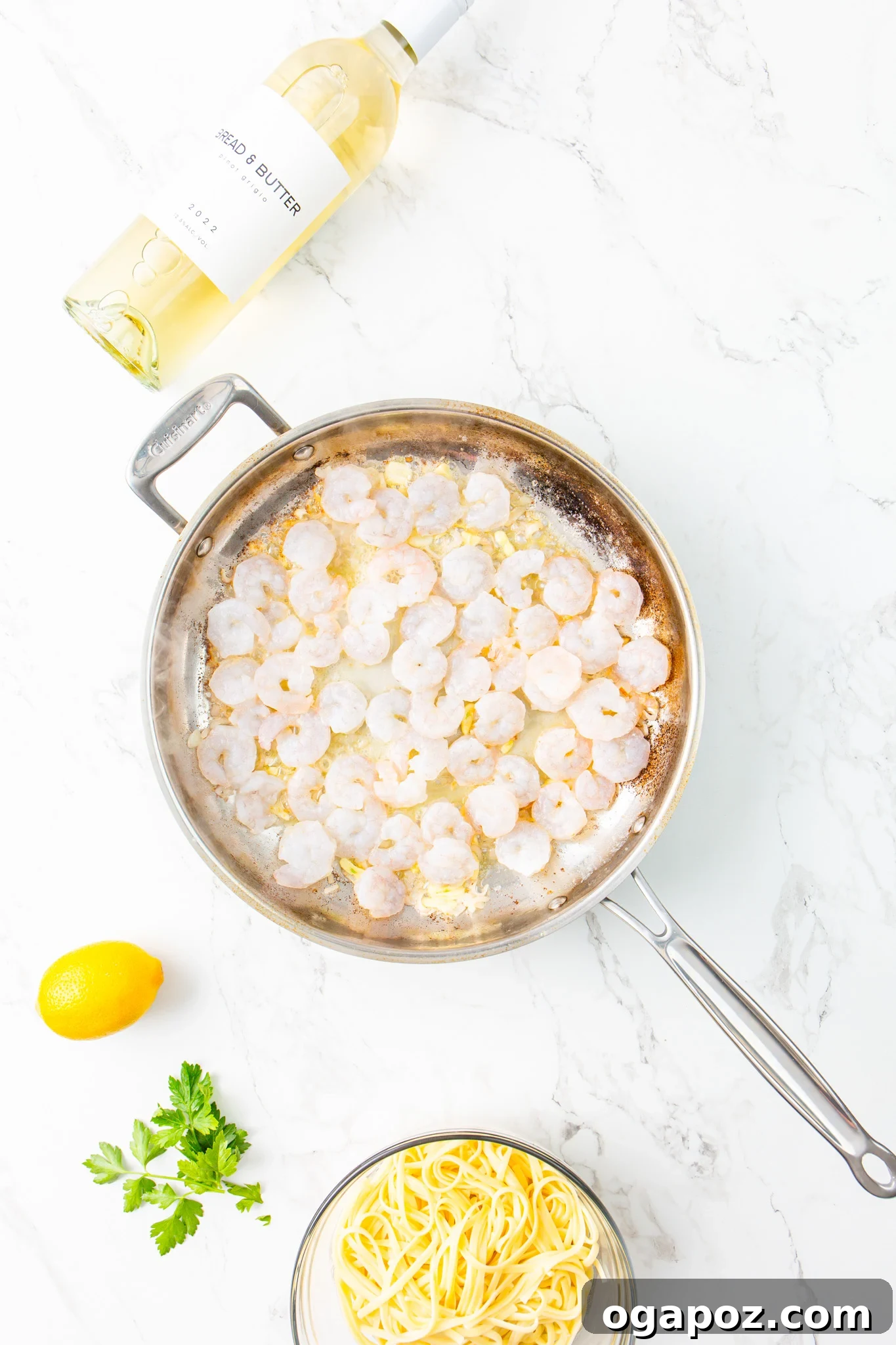 Sun-Kissed Lemon Garlic Shrimp Linguine 9 Shrimp cooking in a skillet with garlic and onion for Lemon Garlic Shrimp Pasta.