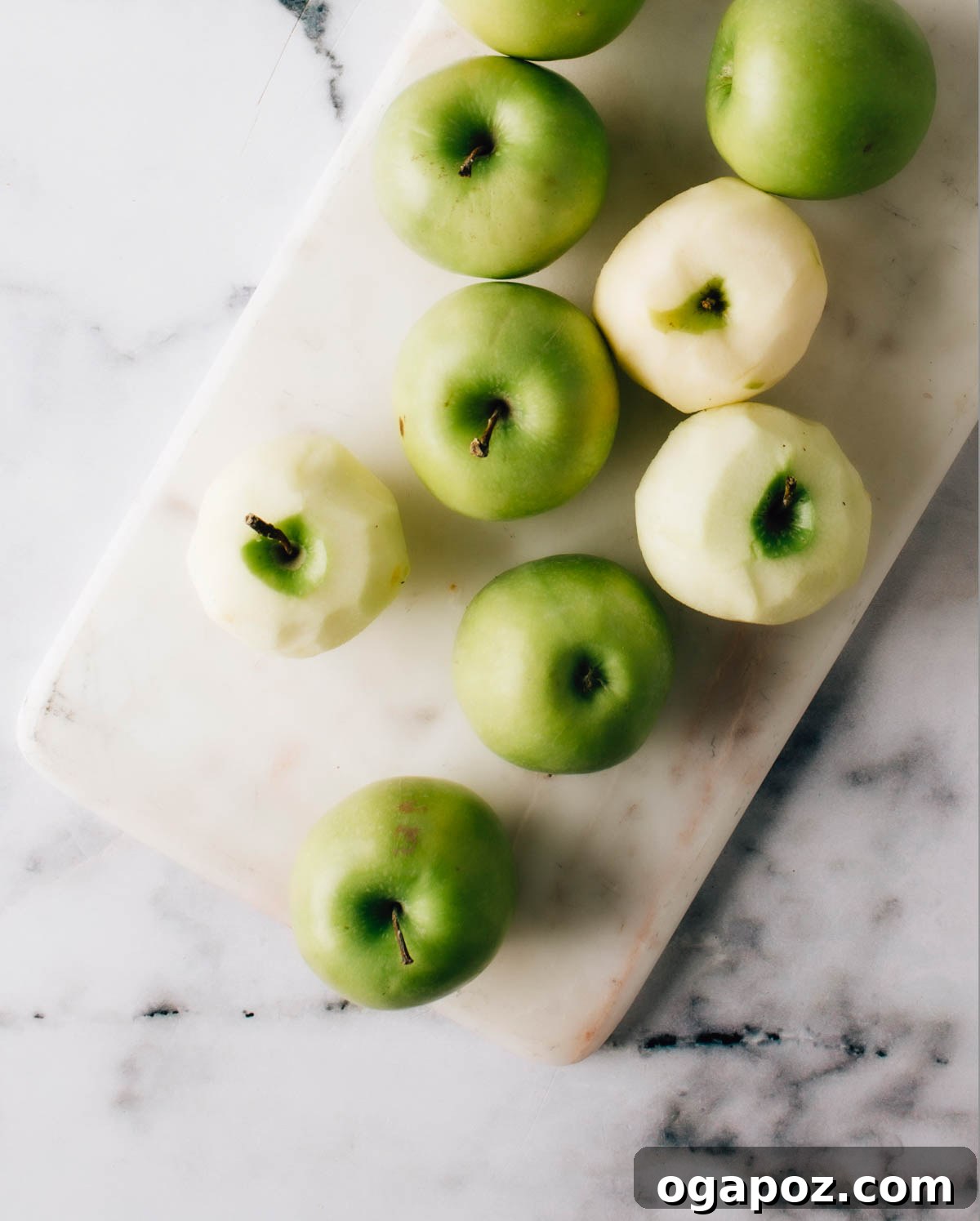 Chai-Spiced Apple Pie 3 A close-up shot of hands peeling fresh apples on a wooden cutting board, ready for the pie filling.