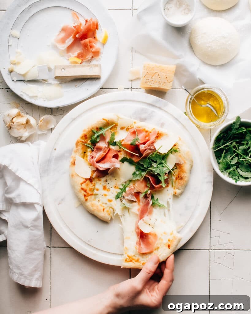 Parma Arugula Elegance 2 Delicious Prosciutto di Parma Pizza with fresh arugula and shaved Grana Padano cheese on a wooden board.