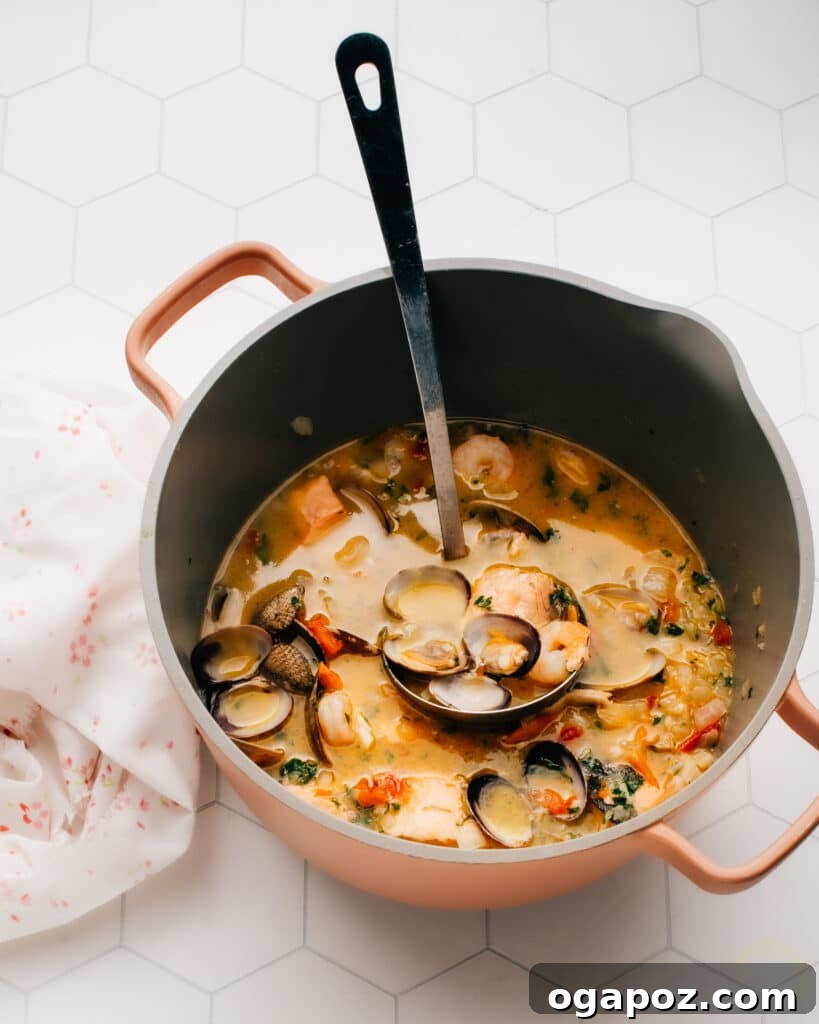 Authentic San Francisco Seafood Cioppino 3 Close-up of a rustic bowl of Cioppino, showcasing the rich red broth, a variety of seafood, and a sprinkle of fresh parsley.