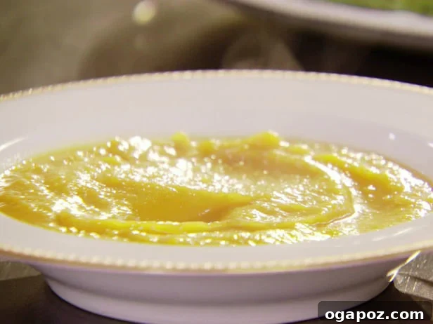 Butternut Squash Soup Rich and creamy butternut squash soup in a bowl, garnished with a swirl of cream