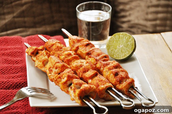 Spicy Chicken Skewers Spicy chicken skewers grilled to perfection, served with a side of sauce