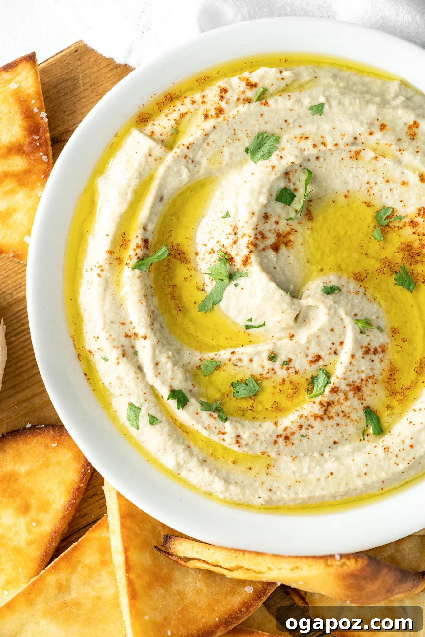 Smoky Roasted Eggplant Dip 2 A bowl of creamy Baba Ghanoush garnished with olive oil and parsley.