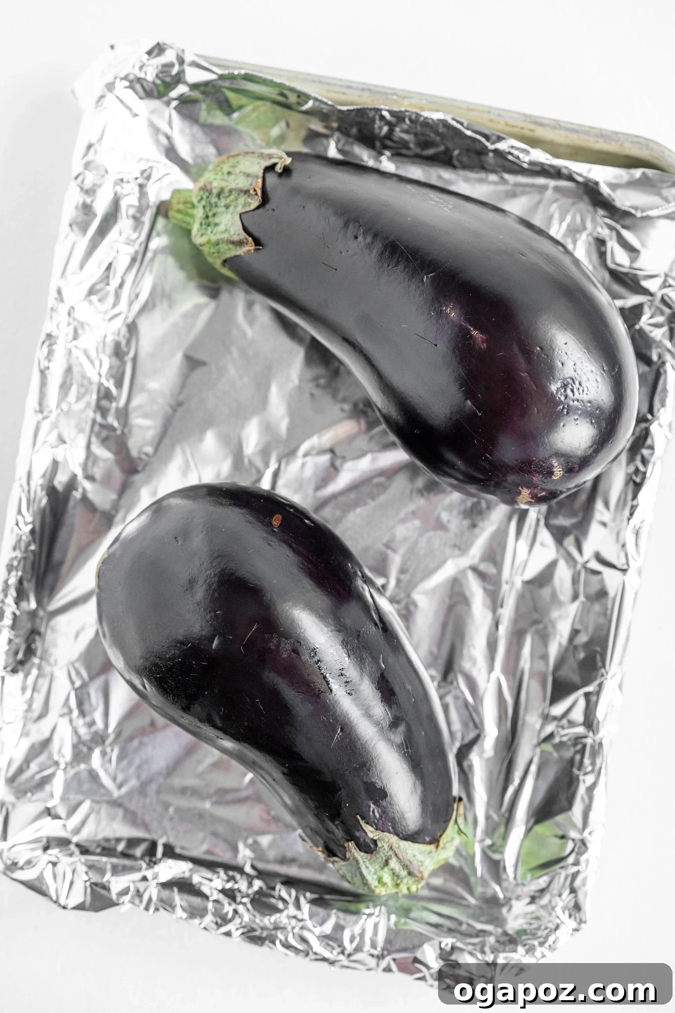 Smoky Roasted Eggplant Dip 5 Whole eggplants prepared for roasting on a baking tray.