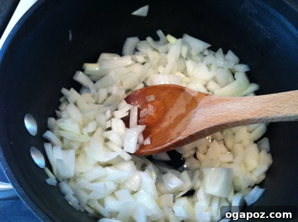 Golden Roasted Butternut Bliss 5 Sautéing chopped onions and garlic in a saucepan for soup base