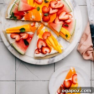 This Easy Fruit Pizza recipe has the best, super-fluffy cream cheese frosting and an easy sugar cookie base. You can make fun, beautiful fruit designs into Easter eggs, a patriotic flag for Memorial Day or Canada Day, or any holiday.